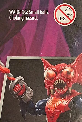 The back of Mantenna's action figure packaging with the child safety label reading WARNING: Small balls. Choking hazard.