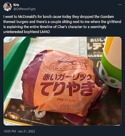Photo from 2022 of a Japanese McDaonald's hamburger, wrapped in a Gundam-themed wrapper. Caption reads "I went to McDonald's for lunch because today they dropped the Gundam themed burgers and there's a couple sitting next to me where the girlfriend is explaining the entire timeline of Char's character to a seemingly uninterested boyfriend LMAO".